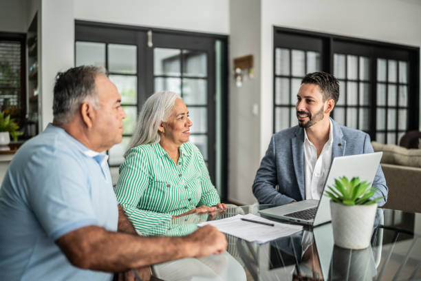 financial advisor having a meeting with senior couple at home financial advisor having a meeting with senior couple at home