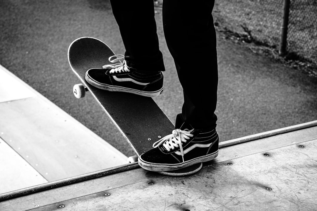 Skateboarder about to drop in on a mini ramp.