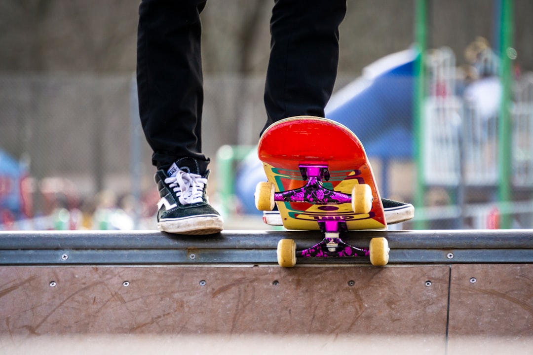 Skateboarder standing on mini ramp